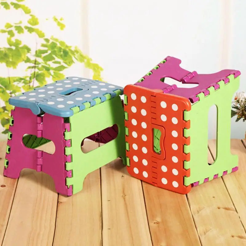 Colorful folding stools with polka dot patterns on a wooden floor.