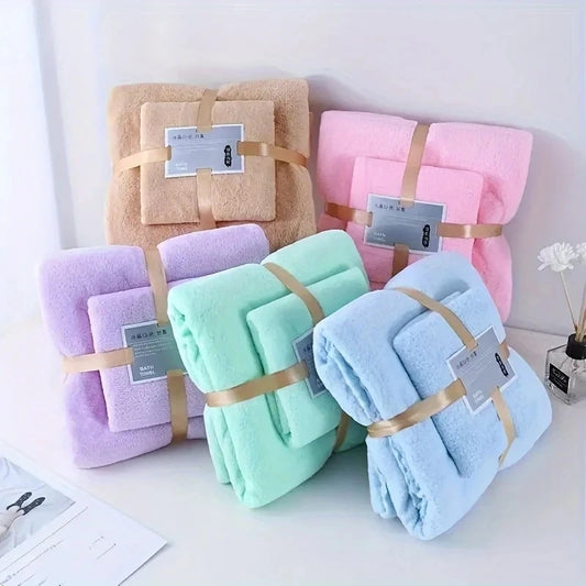Set of folded blankets in various colors with tags on a white surface.