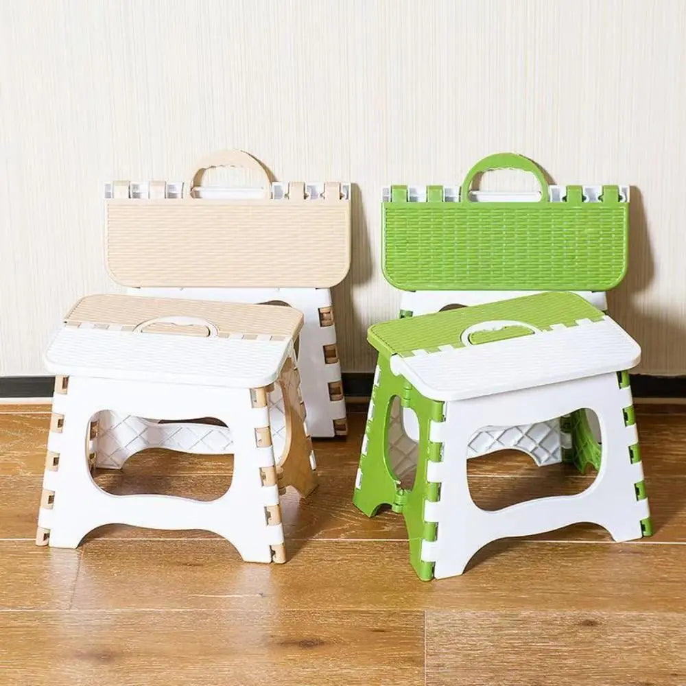 Set of three folding stools in beige, green, and white on a wooden floor.