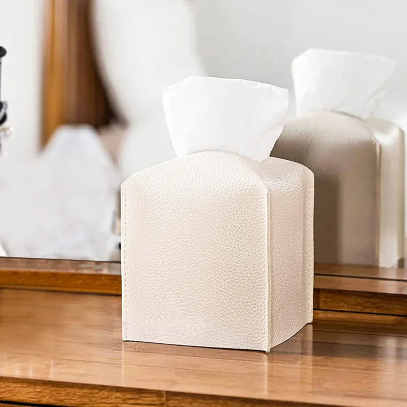 Beige cube-shaped ottoman tissue container
